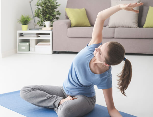 woman-practicing-yoga-at-home-VXZRF8D.jpg